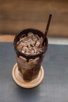 Iced coffee on wooden table photo