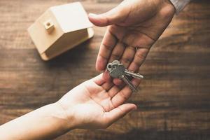 Real estate agent giving keys to customer photo
