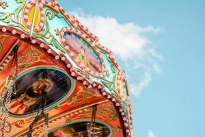 Colorful amusement ride against blue sky photo