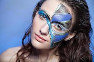 beautiful fashion woman color face art portrait on blue background photo