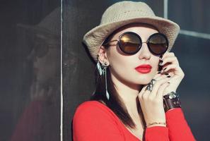 Young beautiful girl in hat and sunglasses photo