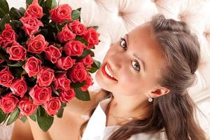 Beautiful woman with a bouquet of roses photo