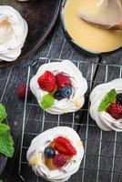 Homemade pavlova meringue with fresh berries photo
