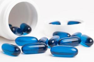blue pills of vitamin and medicine on white background