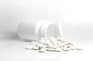 white pills out of pill bottle photo