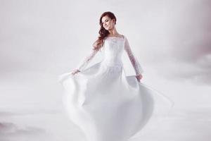 Beautiful bride in wedding dress, abstract soft background photo