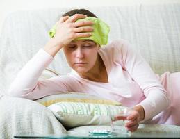 Woman with headache at home photo