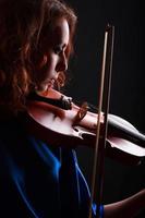 Portrait of a young female playing the violin photo