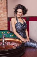 Dark hair elegant woman in casino photo