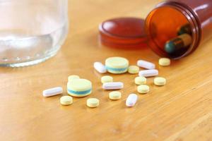 Medicine on wooden table photo