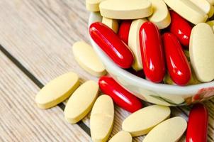 Vitamin supplements in a bowl photo