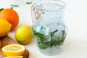 ice and mint in a jug for a cocktail, lemon slices photo
