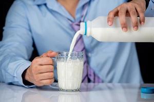 Man pouring milk photo