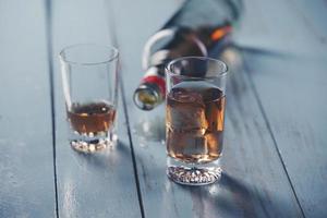 Glasses and a bottle of alcohol  photo