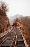 Train tracks between rocky hills photo