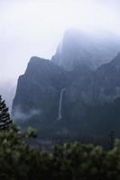 Waterfall on mountain cliff photo