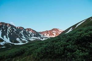 Sunlight on snowy mountain range  photo