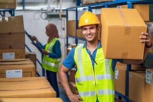 Indian worker man holding cardboard box 