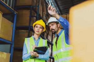 Manager of warehouse and worker in local warehouse photo