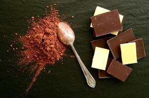 Chocolate bars with heap of cacao powder photo