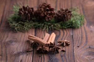 Cinnamon sticks and star anise on brown rustic wooden background photo