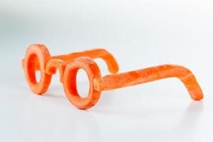 Concept glasses of carrot, benefits view. photo