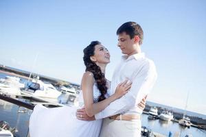 bride and groom on the background of  yacht club, young photo