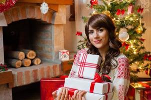 Young woman with christmas present boxes photo