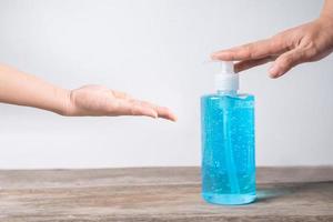 Two people using hand sanitizer  photo