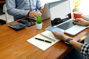 Two people working on laptops in an office photo