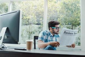 Caucasian man reading business news photo