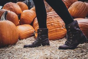 Person standing near pumpkins photo