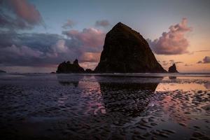 Haystack Rock in Oregon during golden hour photo