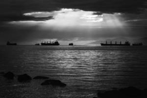 Grayscale of ships on water photo