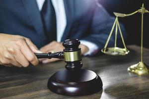 Lawyer uses wooden gavel photo