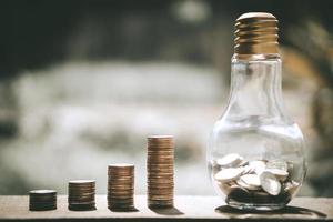 Coin stacks with bottled glass bank photo