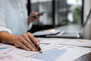 Business person at desk calculating expenses  photo