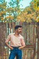 Man posing in front of wooden gate photo