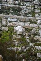 Skull carving in brick wall photo