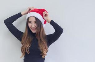 Portrait of woman wearing a red Santa hat photo