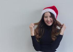 Woman wearing red Christmas hat photo