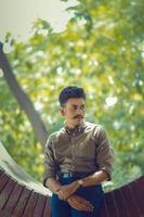 Young man standing in outdoor window photo