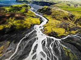 Aerial view of river flowing through mountains photo