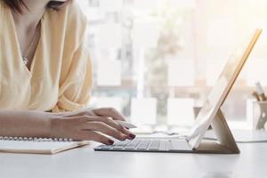 Close up of woman working on computer  photo