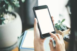 Close-up of person using smartphone with blank screen photo