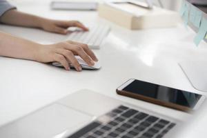 Close-up of professional working at desk photo