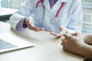 Close-up of doctor talking with patient photo