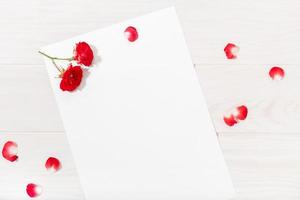 Top view of paper with red roses photo