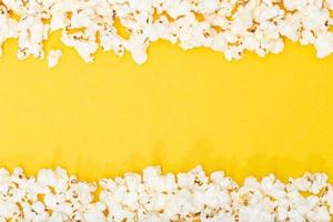 Top view of a popcorn border on a yellow background photo