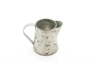 Rustic metal pitcher on white background